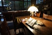 A cozy reading nook featuring a decorative table lamp.