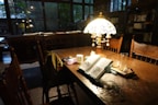 A cozy reading nook featuring a decorative table lamp.
