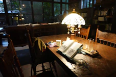 Close-up of a cozy reading nook with a framed authorframe book on a wooden table.