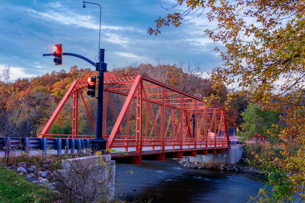 a red bridge over a river