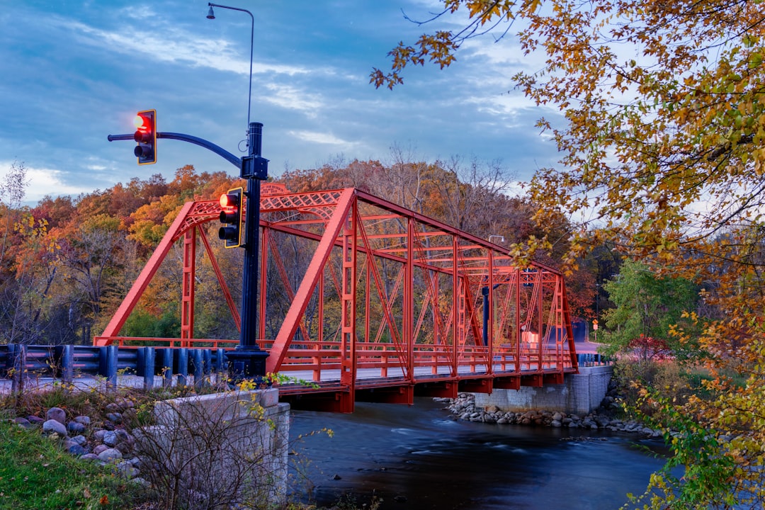 a red bridge over a river, East Delhi Bridge, Ann Arbor, Michigan. Crosses the Huron River.