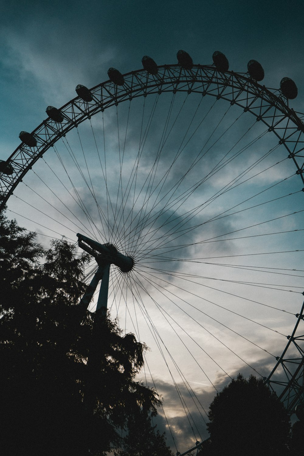 a ferris wheel with trees and blue sky