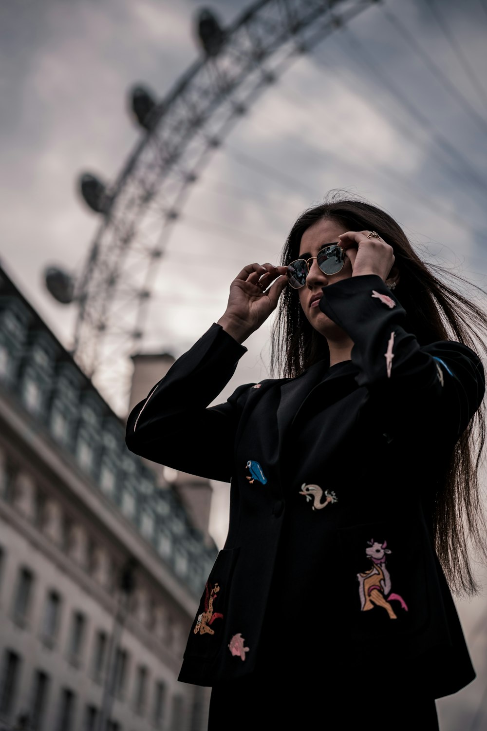 a person wearing sunglasses and holding a phone to the ear