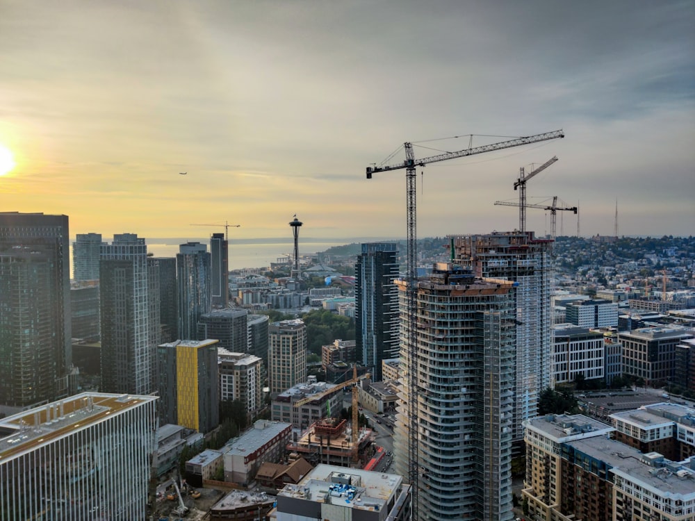 a city with tall buildings and cranes