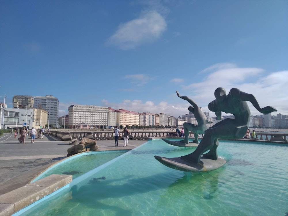 a statue of a man riding a dolphin in a pool