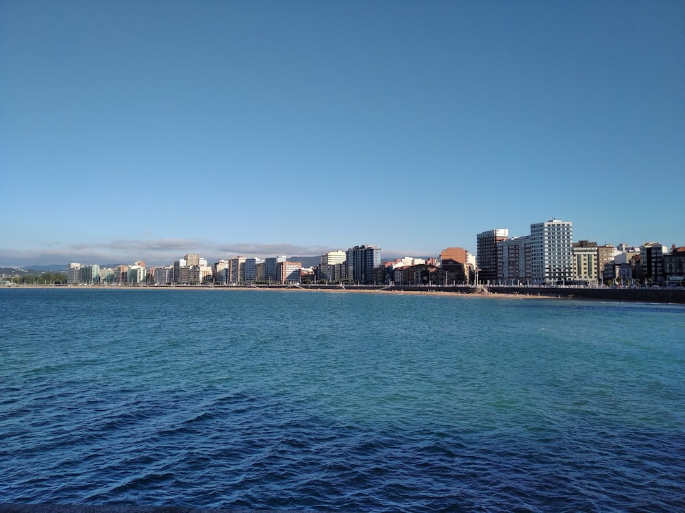 a body of water with a city in the background