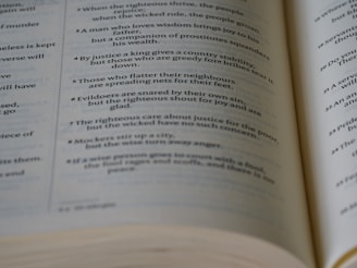 A close-up of a hand flipping through the pages of a modern poetry book.