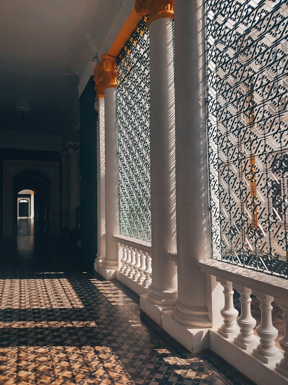 a hallway with white pillars