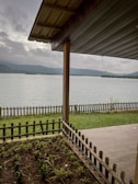 Freshly cleaned cottage porch overlooking a calm lake, ready for guests.