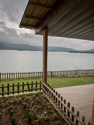 Freshly cleaned cottage porch overlooking a calm lake, ready for guests.