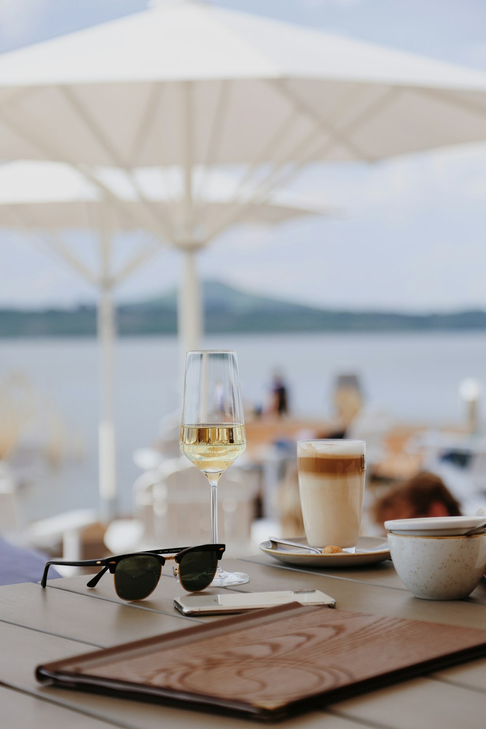 a table with glasses of wine and a plate of food