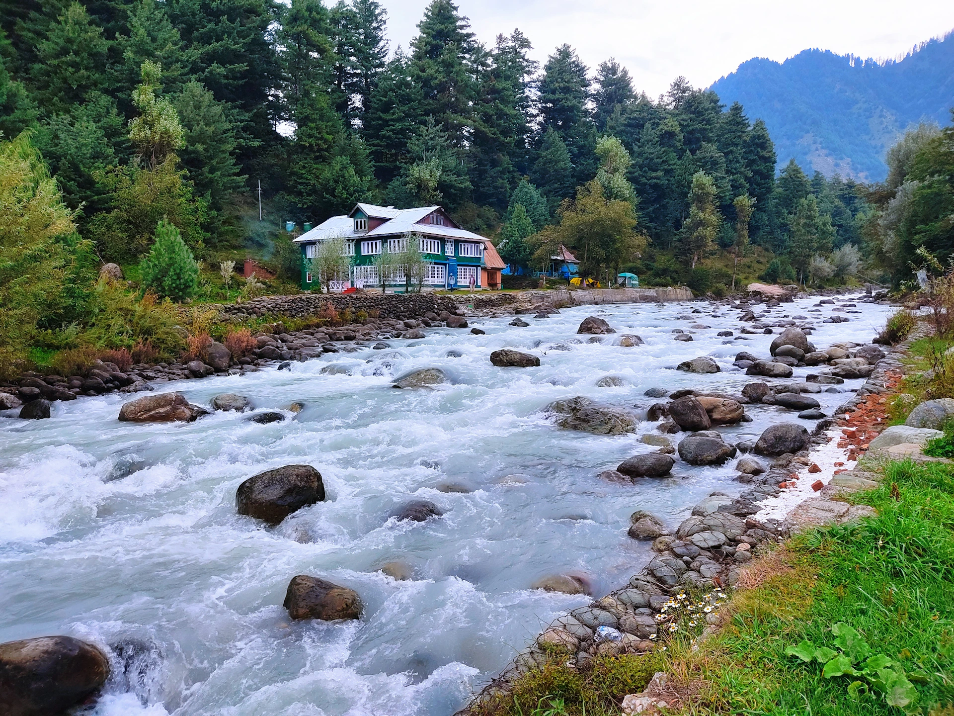 a river with a house in the background
