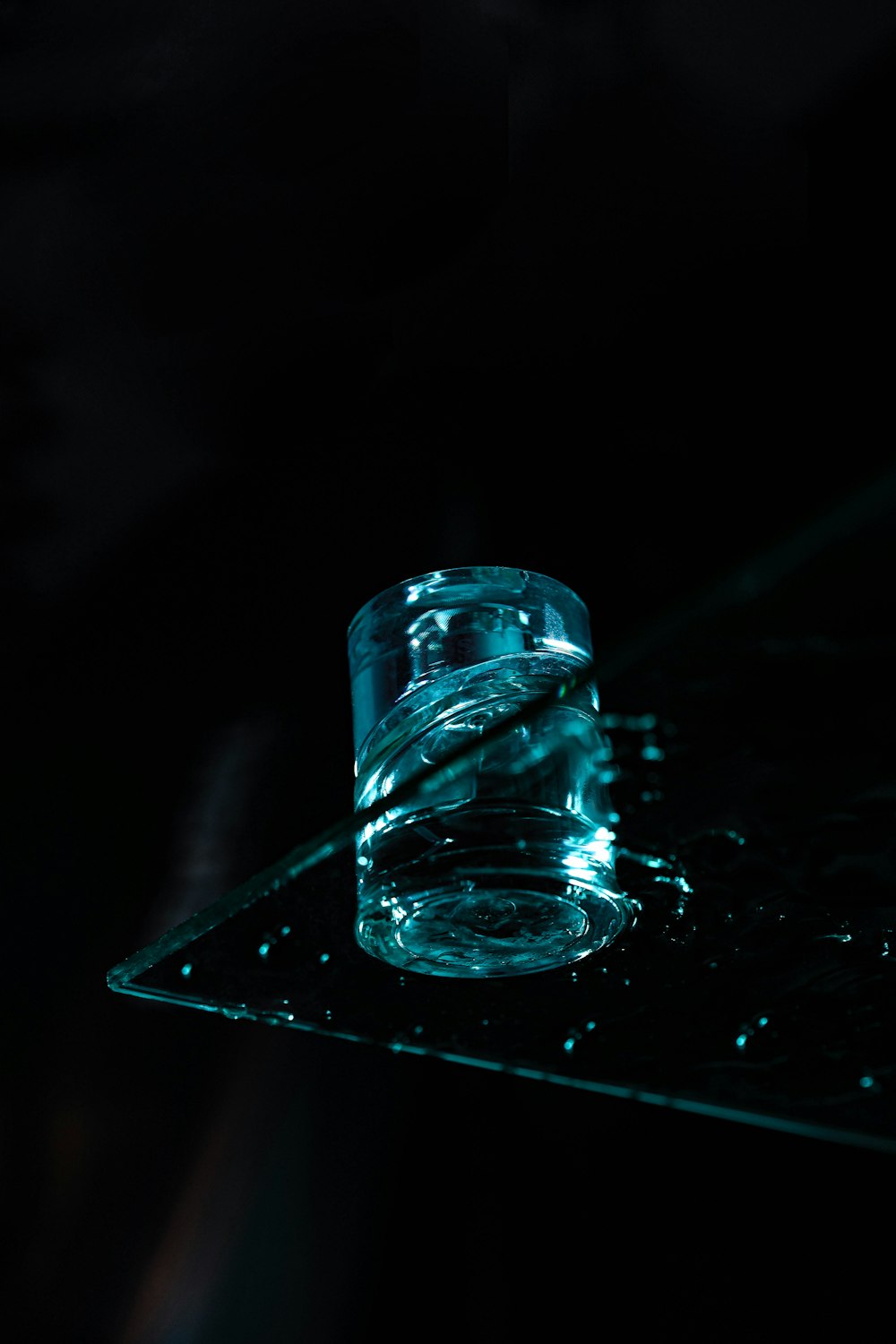 a glass bottle with a blue liquid