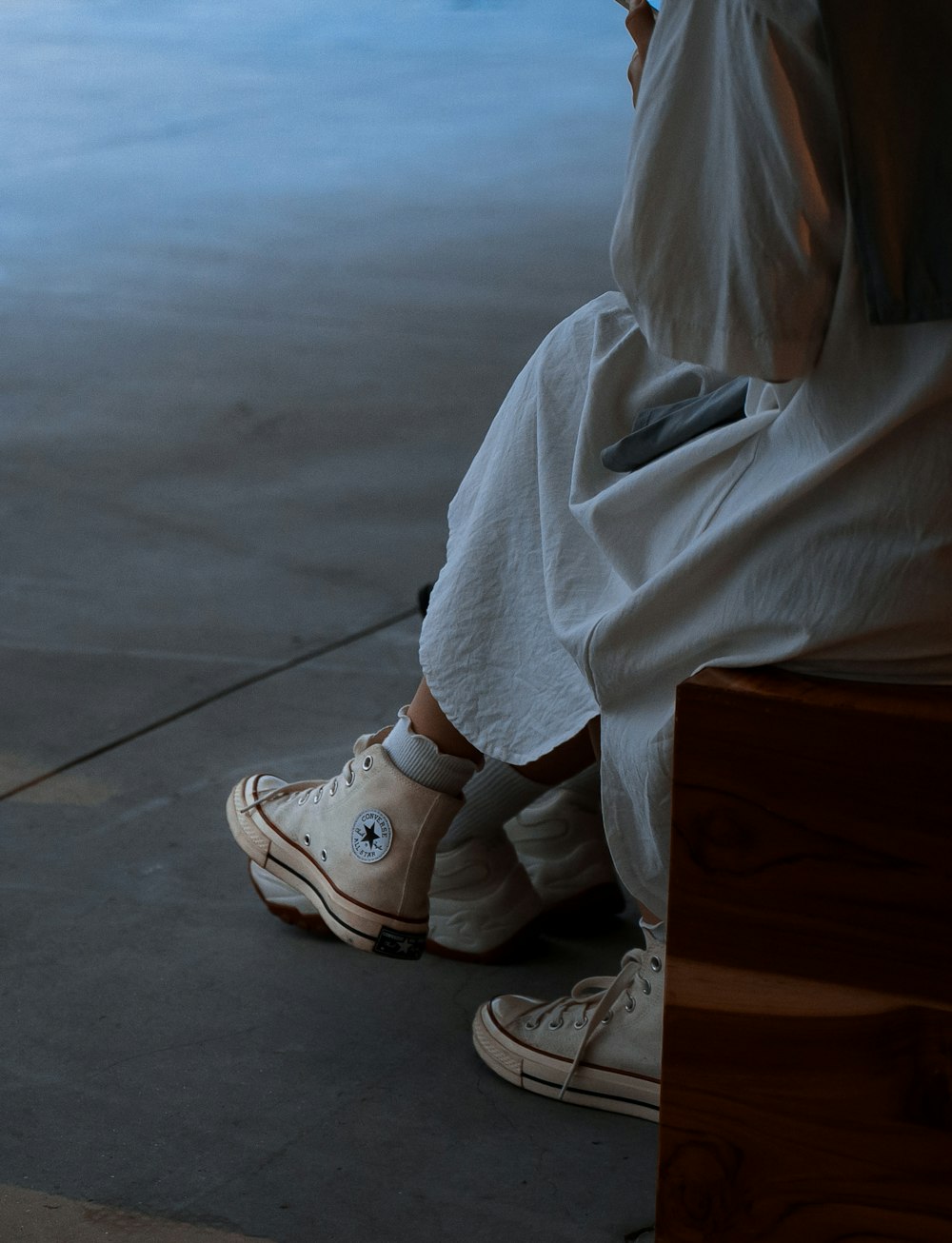 a person wearing a white dress and white shoes