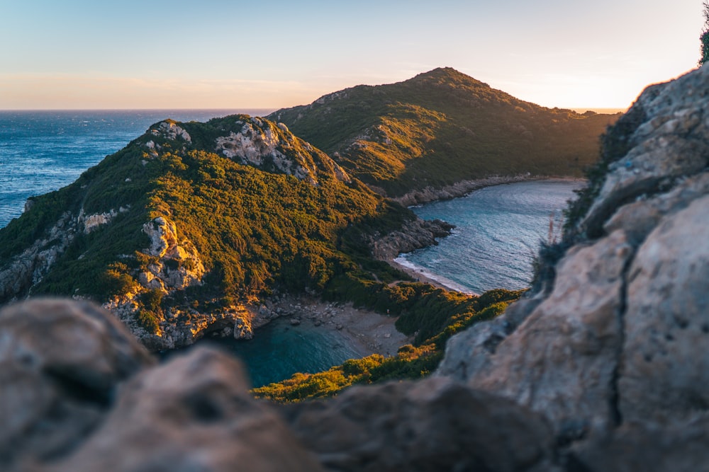 a rocky cliff with a body of water below