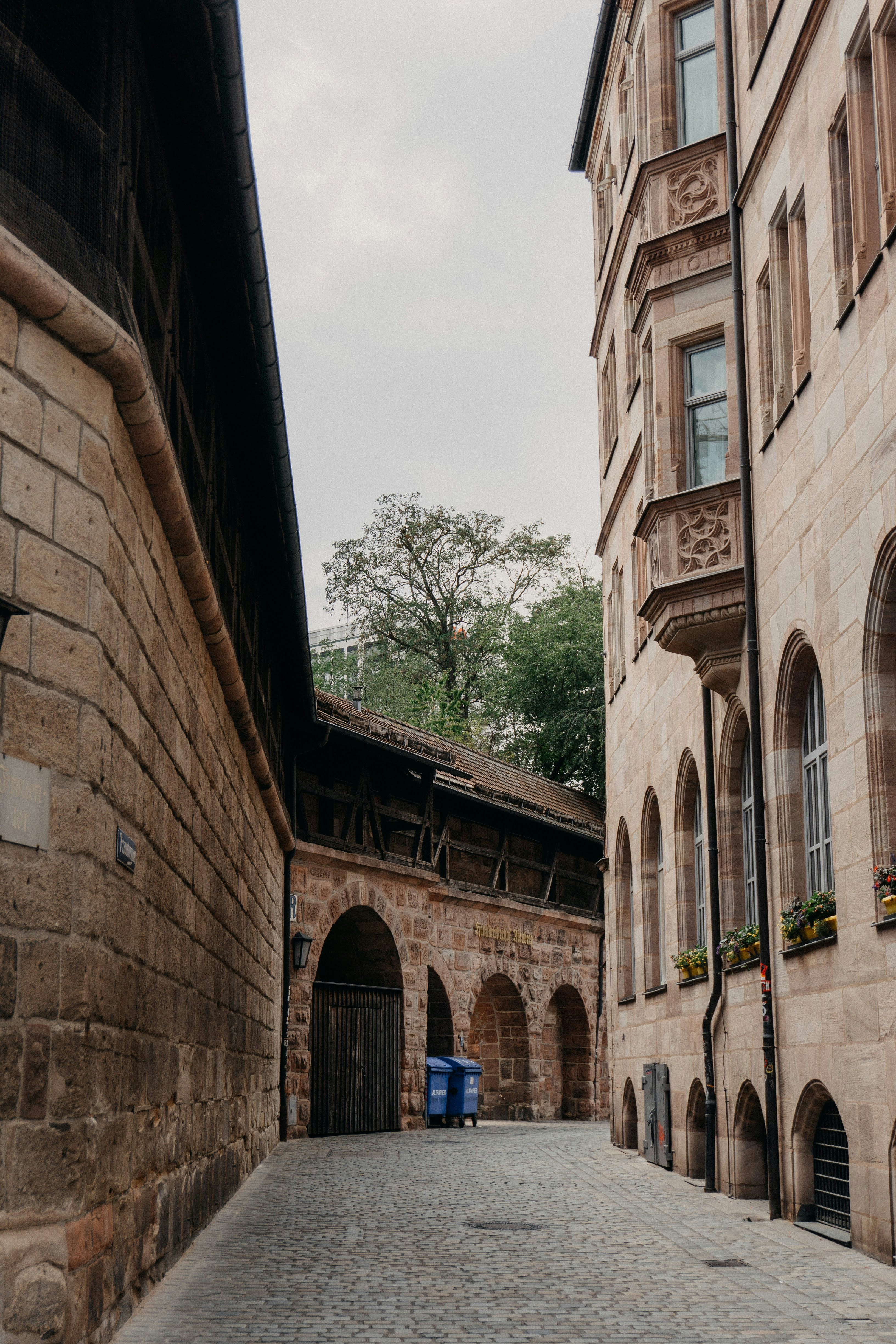 a stone walkway between two buildings