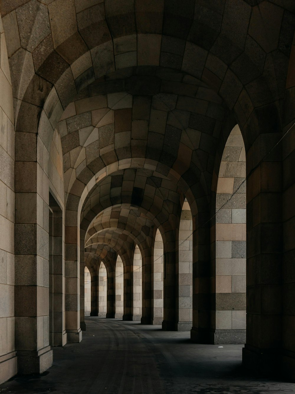 a stone hallway with arched ceilings