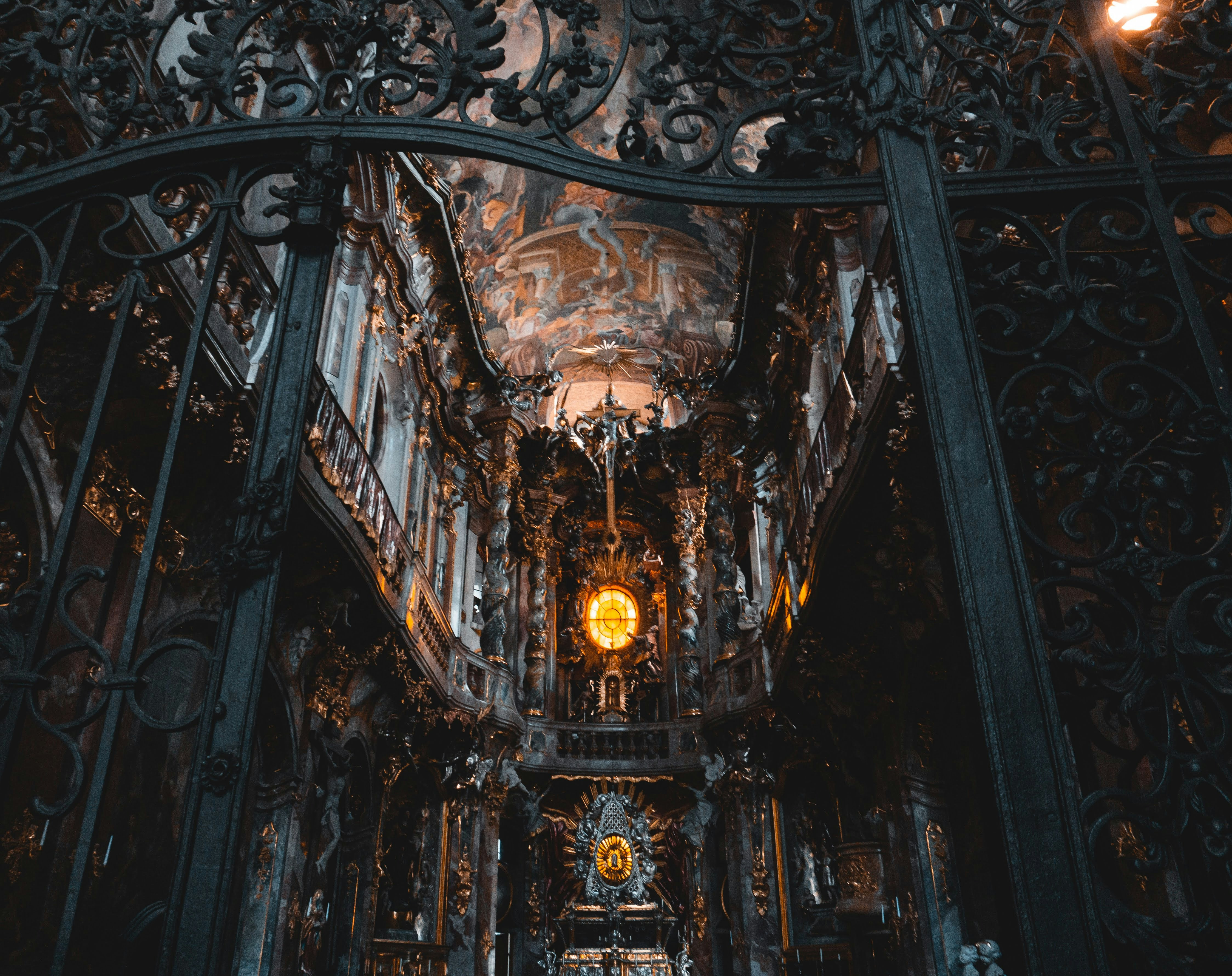 a large ornate ceiling with a clock, Asamkirche, Munich, Germany 1/2