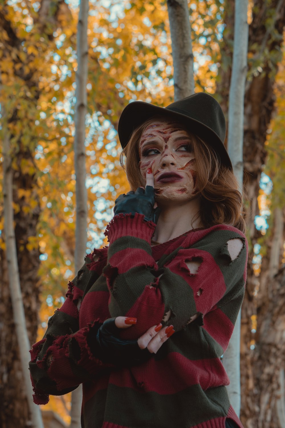 a person wearing a hat and holding flowers