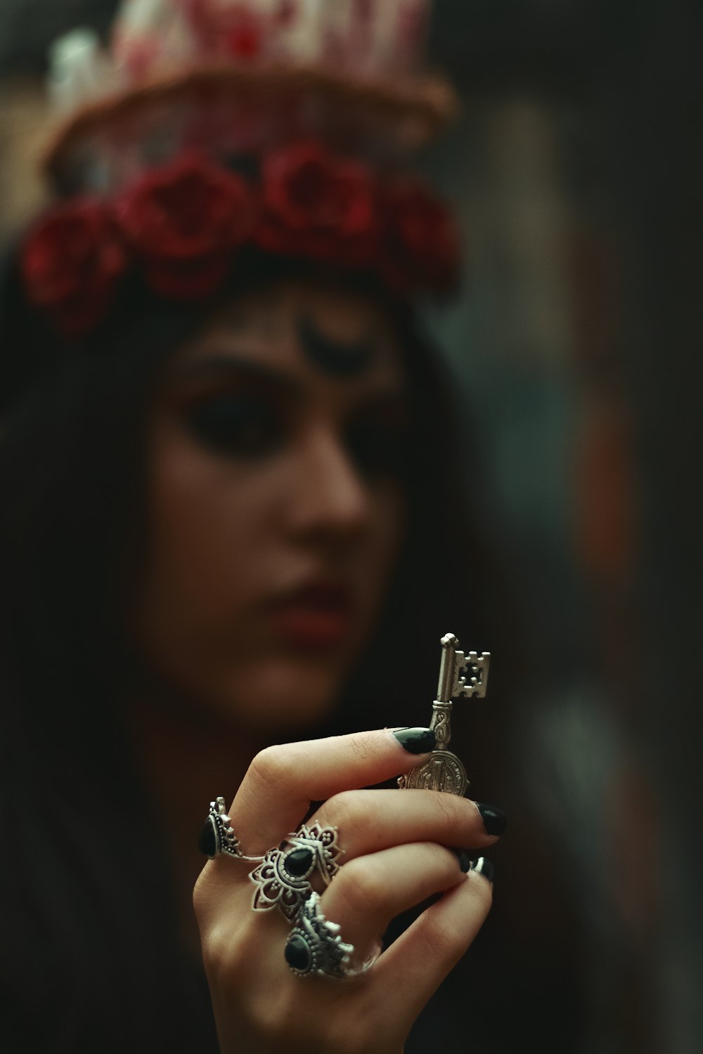 a woman wearing a red and white hat and holding a key