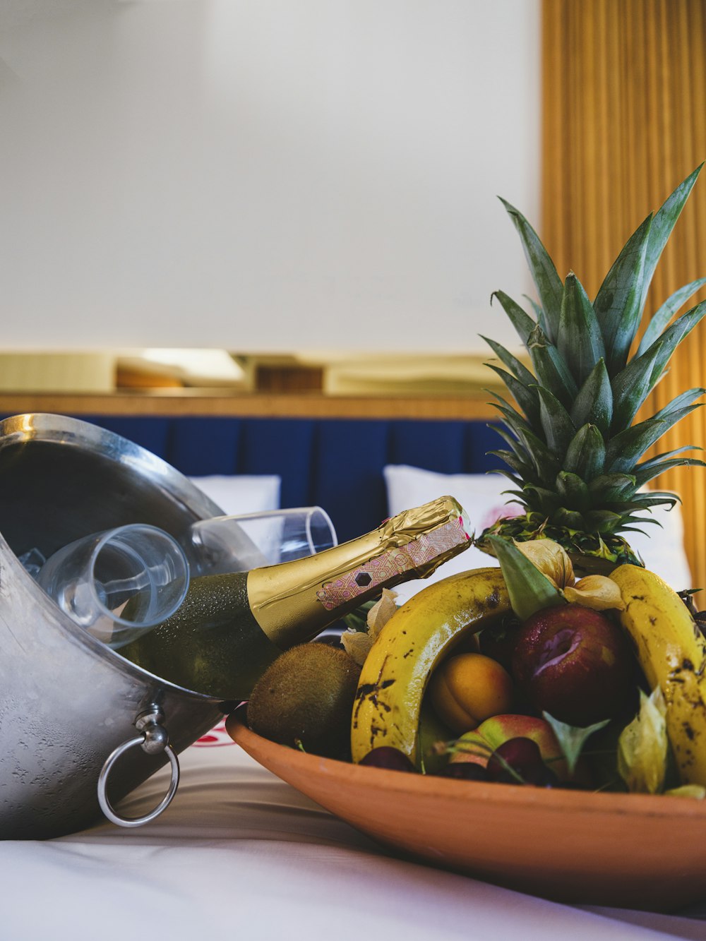 a bowl of fruit and a bottle of wine