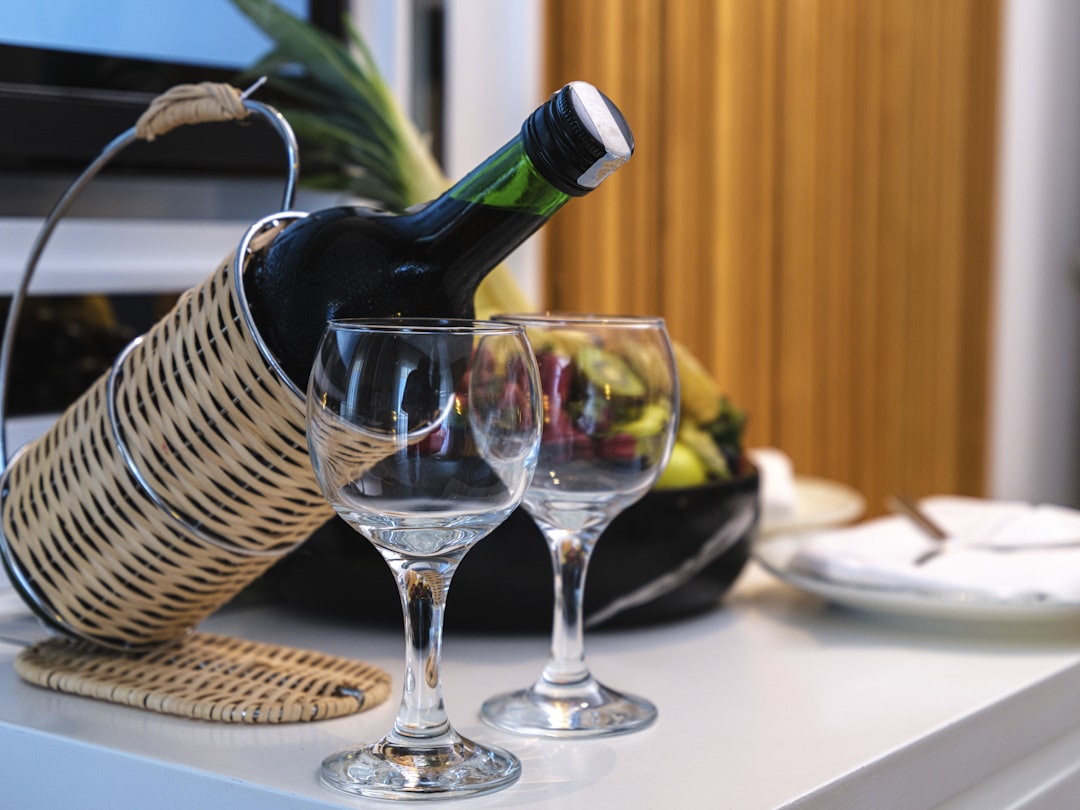 a basket with wine glasses, wine and fruits in the honeymoon room