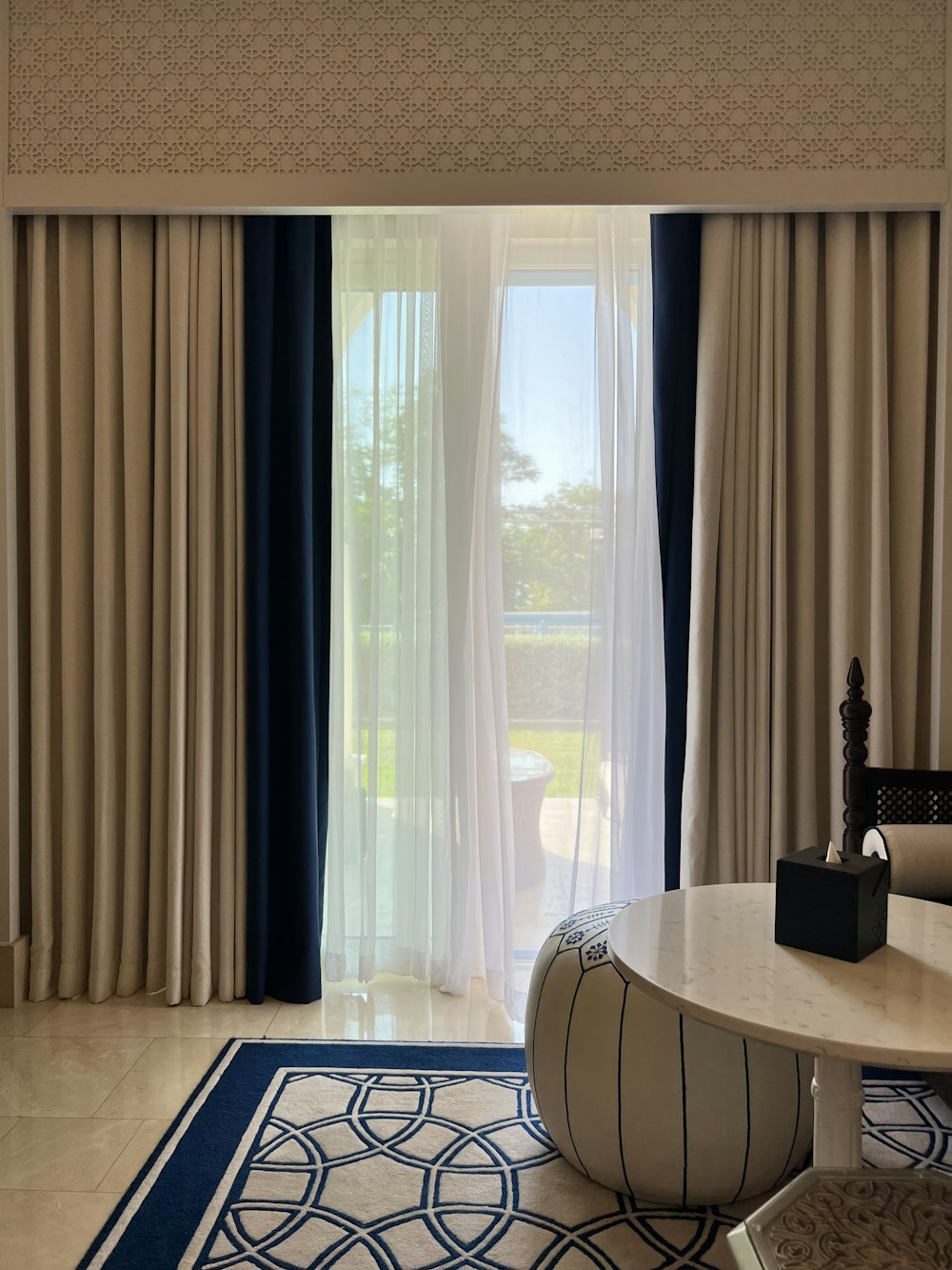 a room with a table and a window with curtains