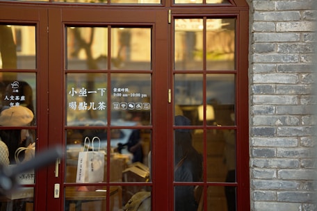 A traveler consulting a detailed Qingdao map at a cozy café, sunlight streaming through the window.