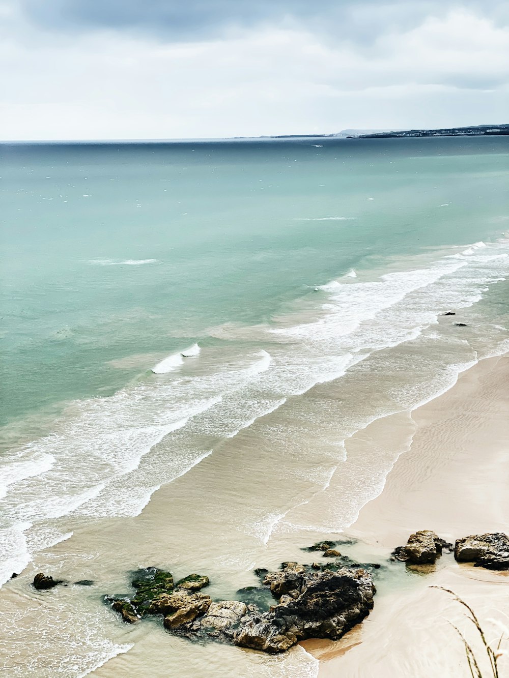 a beach with rocks and water