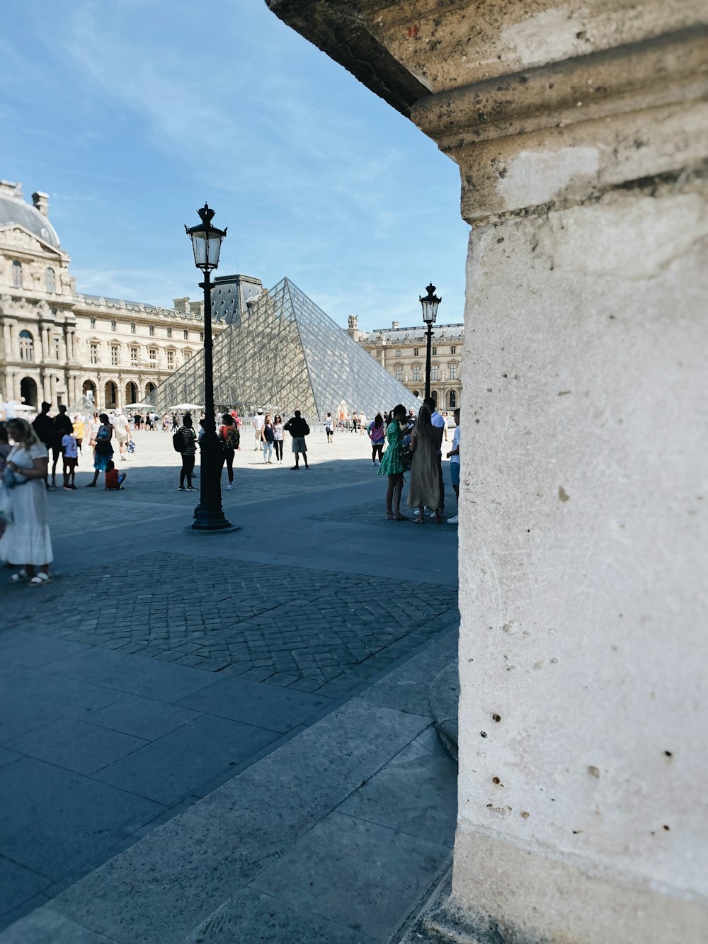 a group of people walking on a stone walkway