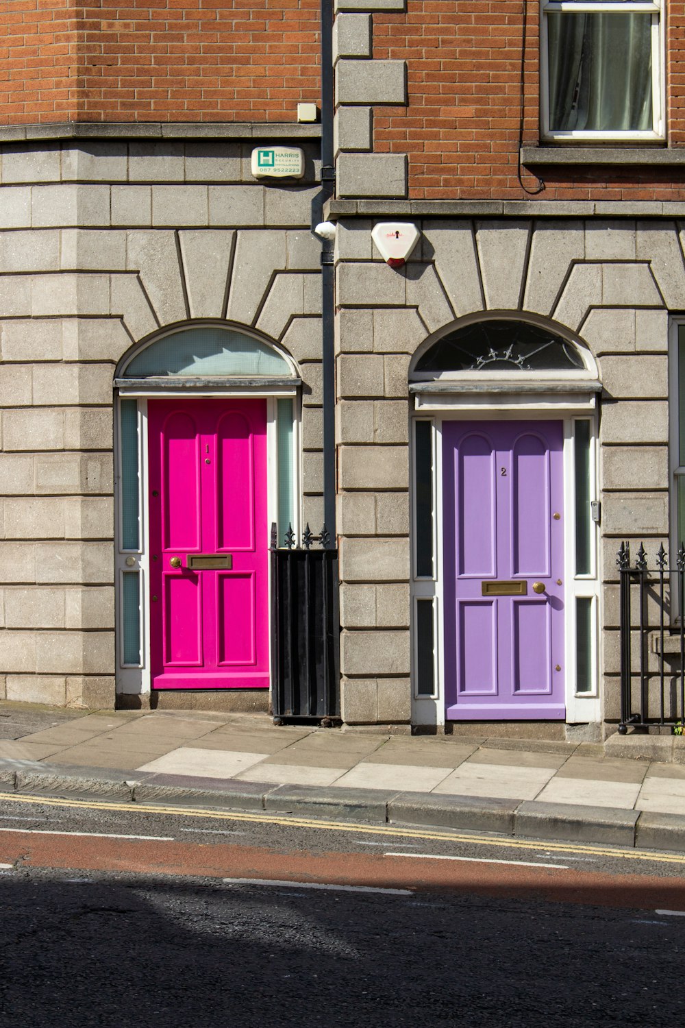 a couple of purple doors on a brick building