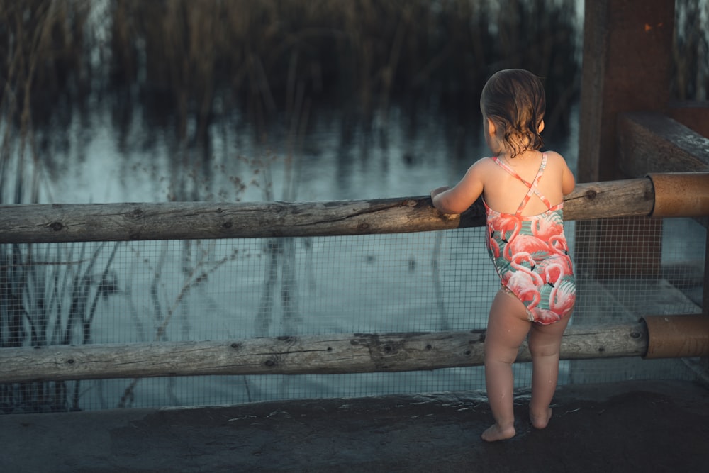 a girl standing on a bridge