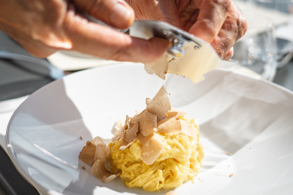 a person cutting a potato