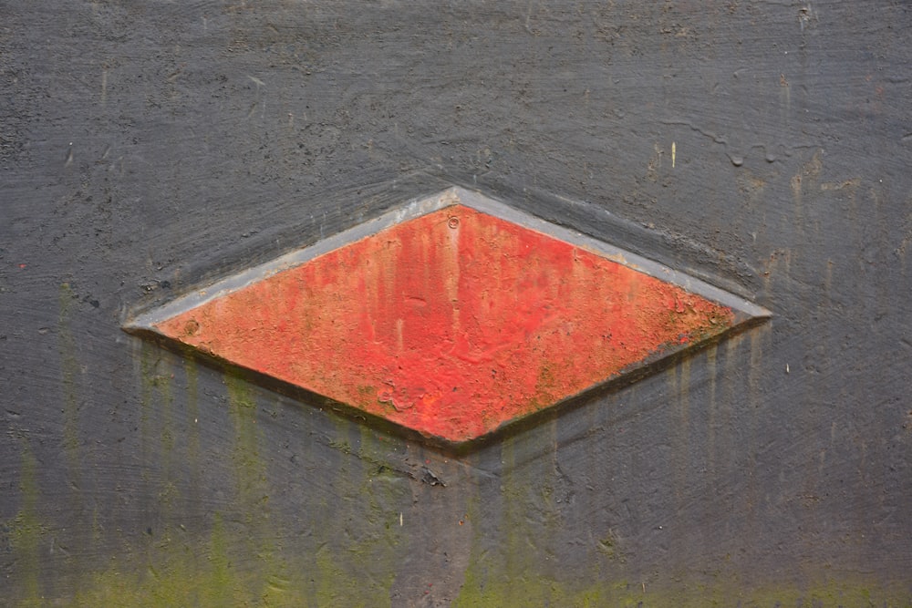 a red square on a black surface