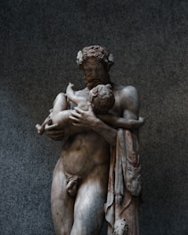 a statue of a man holding a woman