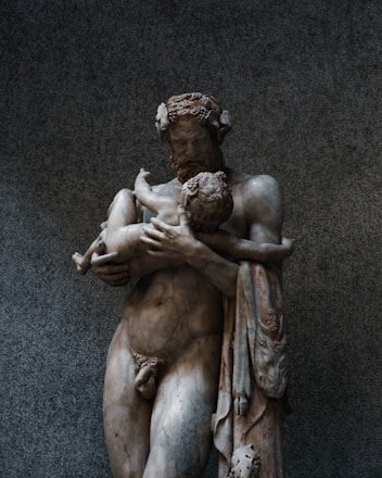 a statue of a man holding a woman