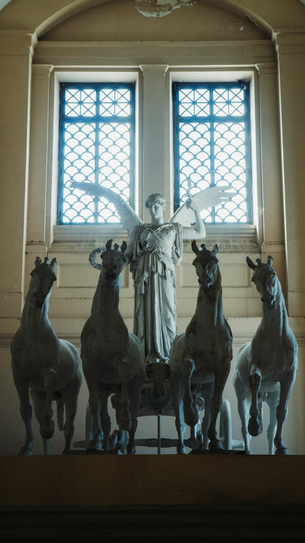 a group of statues in front of a window