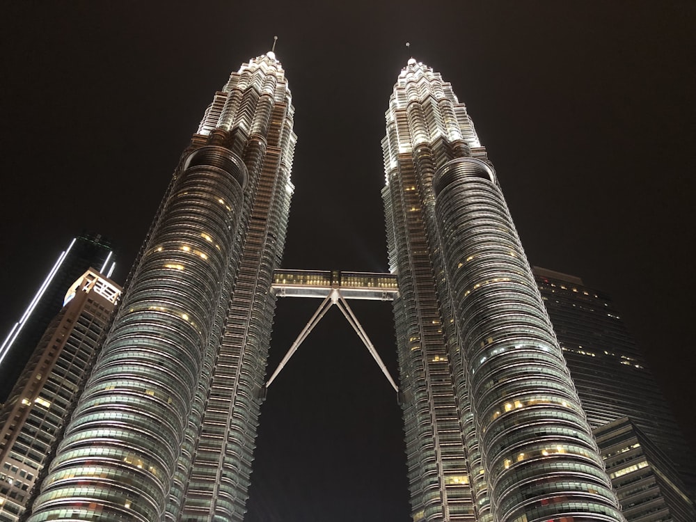 a couple of tall buildings with Petronas Towers in the background