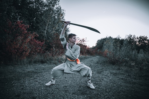 A focused student practicing precise sword strikes in a traditional dojo setting.