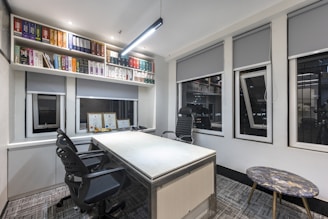 a room with a desk and shelves