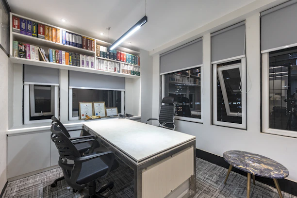 a room with a desk and shelves