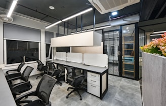 an office with a large white table and chairs