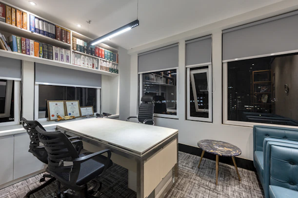 a room with a desk and shelves