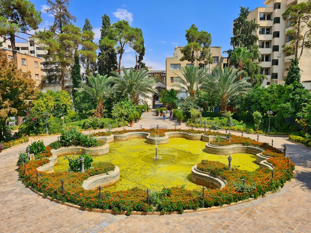 a courtyard with a fountain and trees