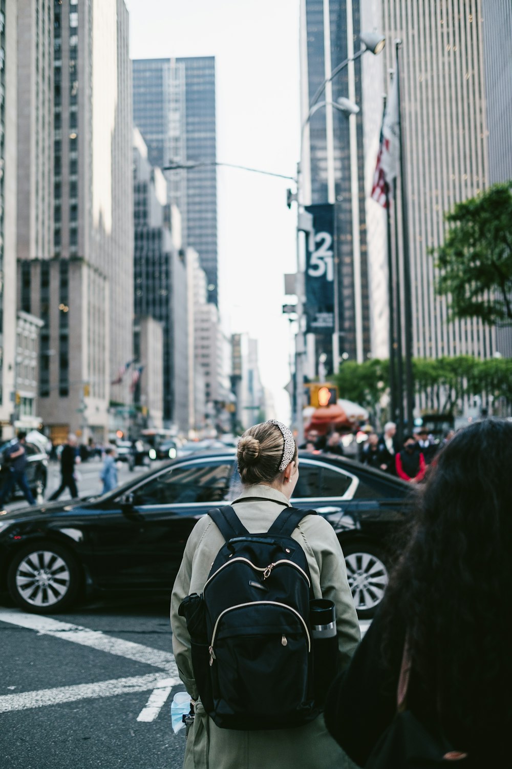 a person with a backpack walking down a busy street