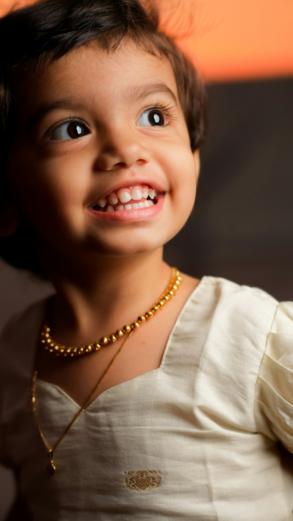 a child with a necklace