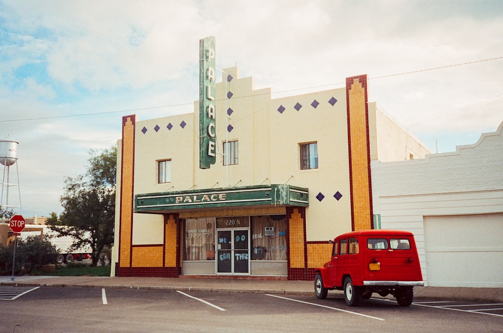 a red truck parked in front of a store