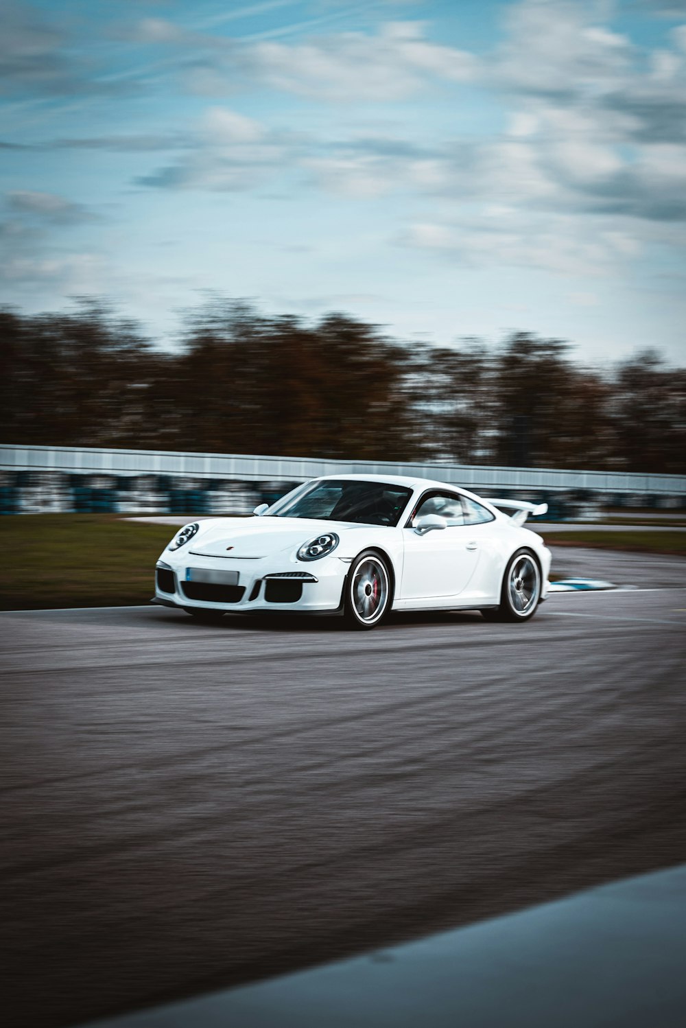a white sports car on a race track