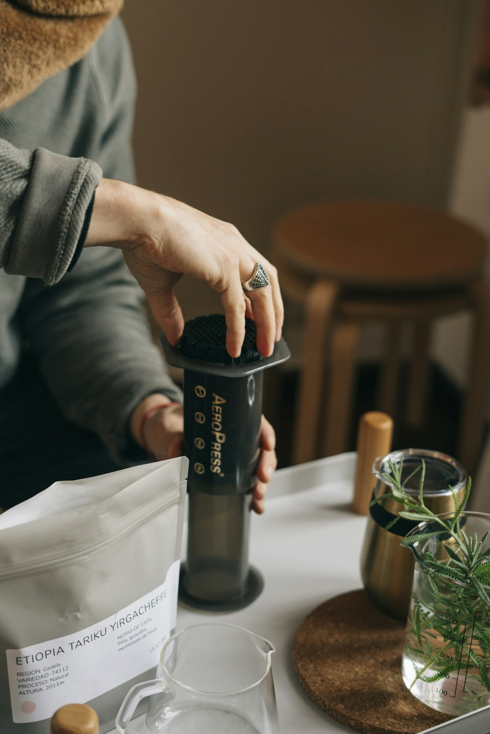 a person holding a black cylindrical object