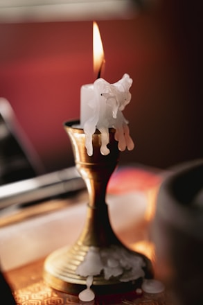 a lit candle with a flame